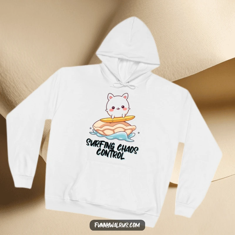 Funny hoodie print of a wobbly, round animal character surfing precariously on a large clam, evoking beachy humor.