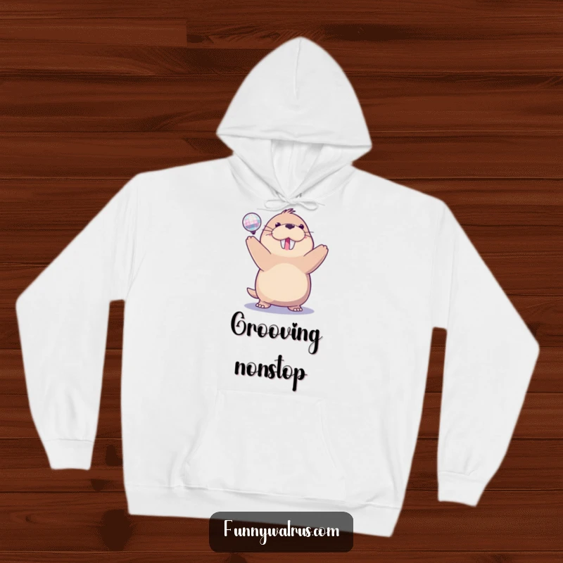 Funny disco walrus hoodie featuring a delighted walrus spinning a small, sparkling disco ball, perfect for cozy celebrations.
